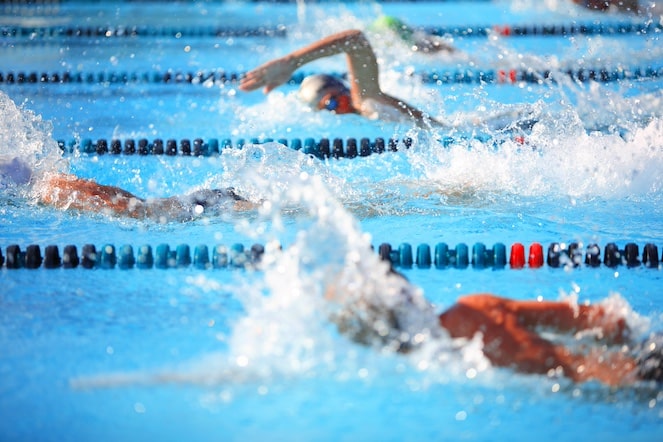 Swimmers in between the ropes in a tight competition.