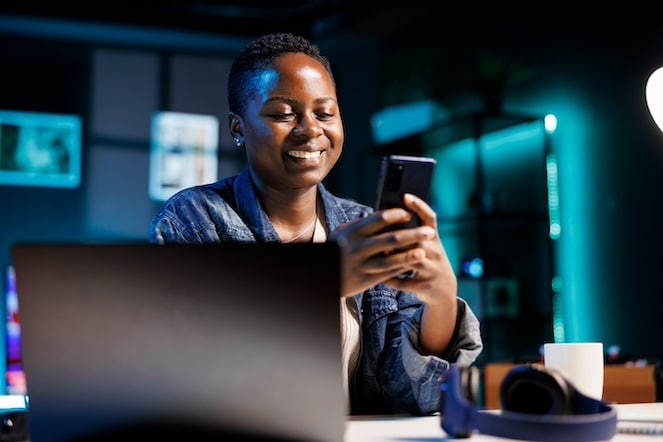 Cheerful student working on her phone