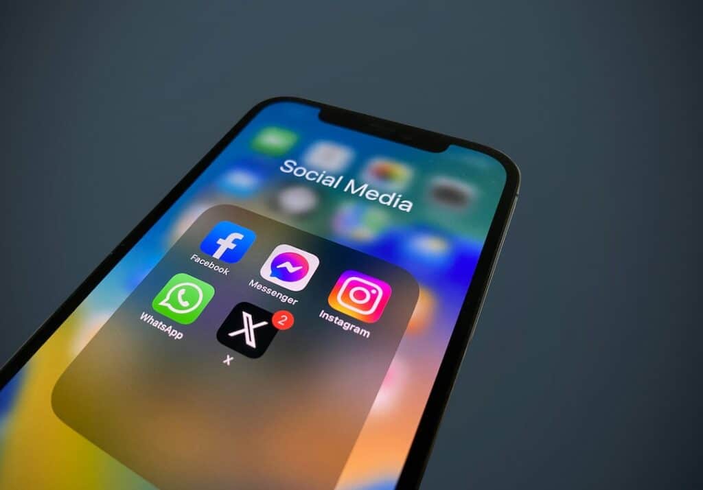 Facebook, messenger, instagram, whatsapp, and Twitter X on the front of a mobile phone.