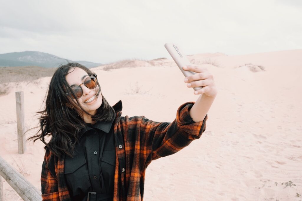 Young women taking a selfie on the beach.