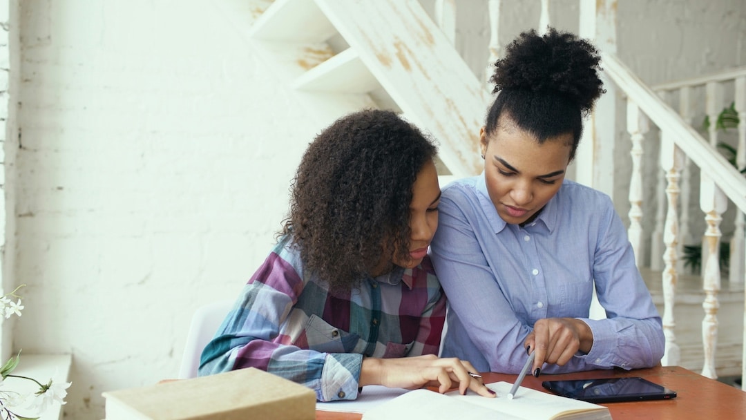 Mom and daughter working together on a project.